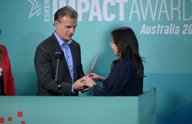 A man gives the award to the woman